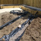 Permeable membrane, pea gravel, trench is backfilled. Drainage in, ready for the new lawn